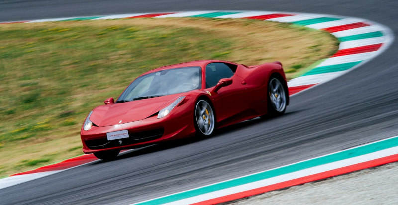 Ferrari fährt eine Kurve mit hoher Geschwindigkeit auf der Monza-Rennstrecke